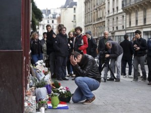 Man Mourns At The Carillon (Photo Credit- AP:Thibault Camus)